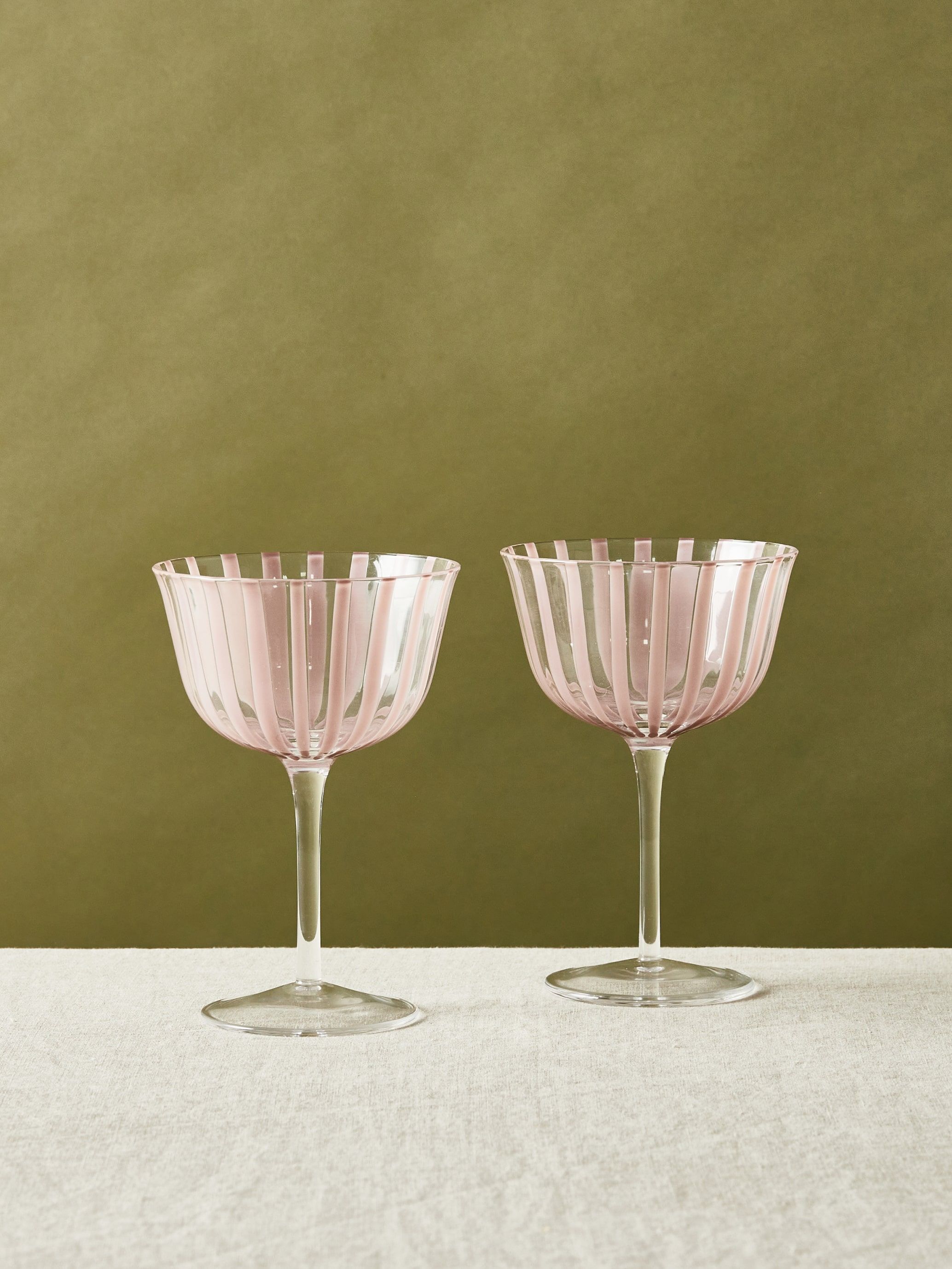 a pair of pink striped champagne glasses