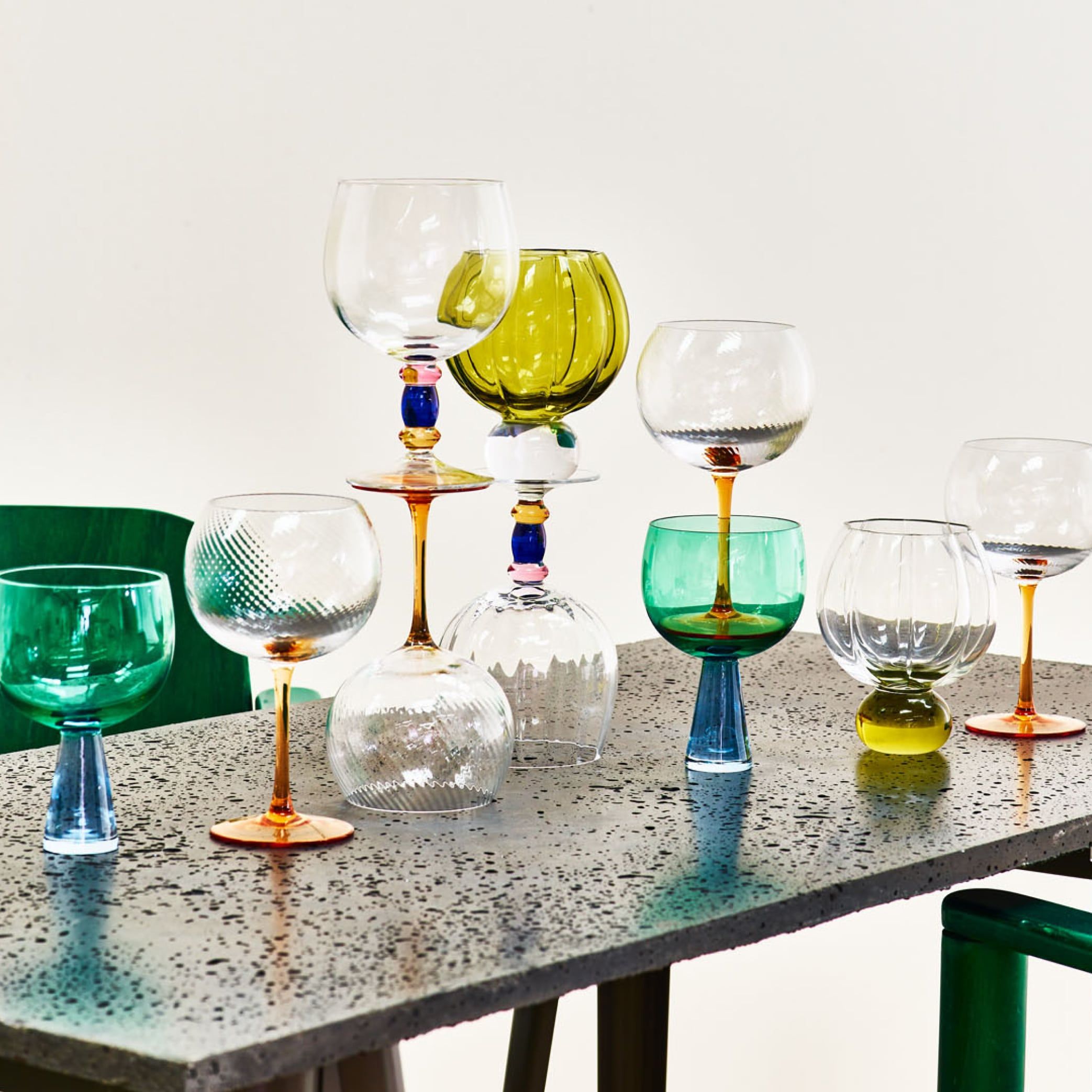 A collection of gin glasses on a dark table 