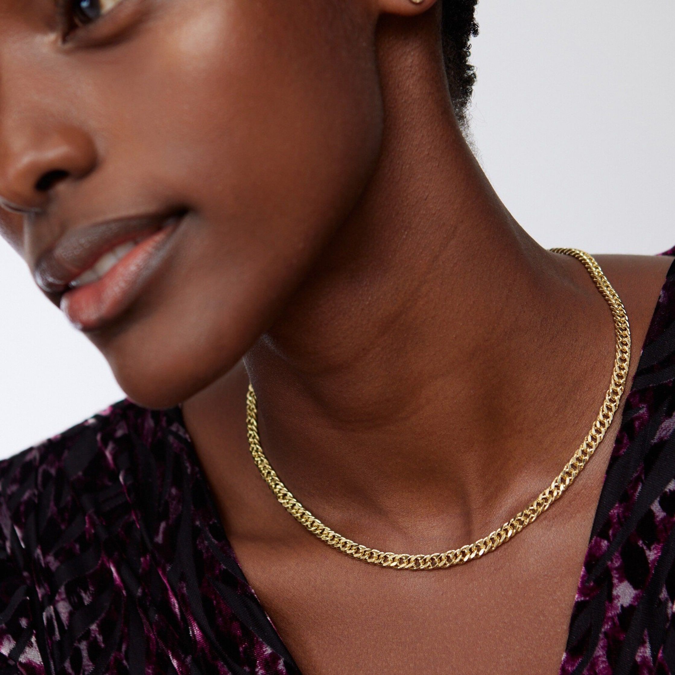 Model wearing a gold box chain necklace 